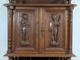 a wooden cabinet with carvings on it in a room