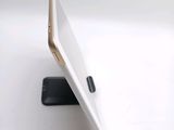 a laptop computer sitting on top of a stand on a table