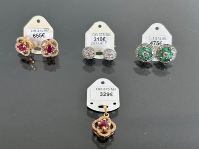 three pairs of earrings and a price tag on a table