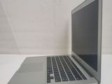 a silver laptop computer sitting on a white table