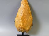 an image of a piece of yellow stone on a black stand