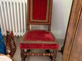 a red chair sitting in a room next to a white radiator