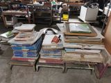 many stacks of papers on a table in a room