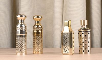 three different types of perfume bottles sitting on a table