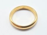 a close up of a gold ring on a white surface