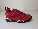 a pair of red sneakers on a white surface