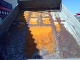 a truck that has some oranges in the back of it