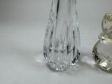 two glass vases sitting next to each other on a table