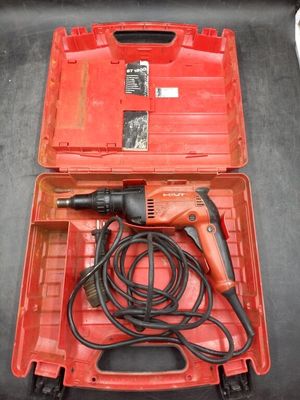 a red box with a drill and a cord in it