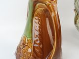 two vases sitting next to each other on a white surface