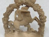 a figurine of a woman riding a horse in a wreath