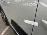 a sticker on the door of a car that is parked in a parking lot