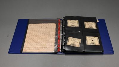 a blue folder with a lot of stamps inside of it