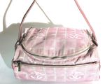 a pink purse that is sitting on a white surface