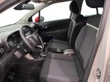 the interior of a small car with the front seats folded down