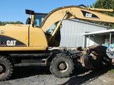 a large yellow construction vehicle parked in front of a building