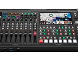 a close up of a digital mixing console with multiple controls