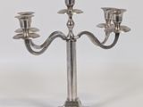 silver plated candelab with three candles on a metal base