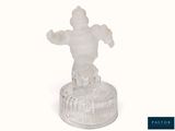 a frosted glass figurine of a man on a pedestal