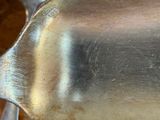 a spoon and a spoon rest on a wooden table