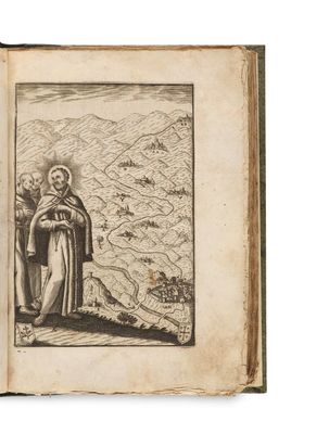 un vieux livre sur lequel figure le dessin d'un homme debout devant une montagne
