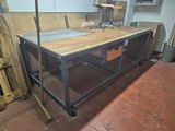 a workbench in the middle of a room with a lot of tools on it