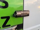 a close up of a door handle on a green and white van
