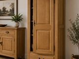 une armoire en bois dont la porte est ouverte, dans un salon