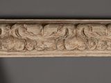 a close up of a carved wood frame with a bird motif on it