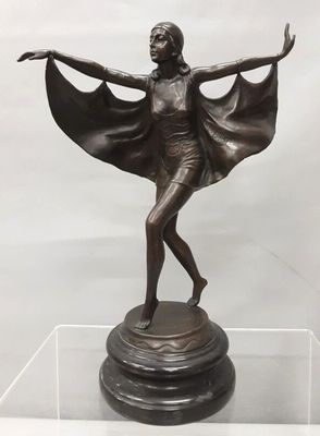 bronze statue of a woman with a cape on top of a pedestal