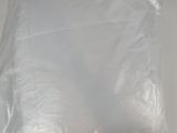 a white pillow on the bed with a plastic bag on it
