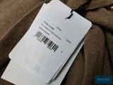 a label on a brown jacket that is attached to a brown jacket