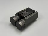 a close up of a pair of binoculars on a white surface