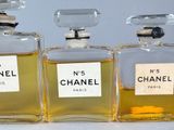 three bottles of chanel perfume sitting next to each other on a table