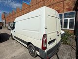a white van parked in front of a brick building