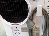 a white air conditioner with a hose attached to it