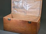 a wooden trunk with a clear plastic cover on it