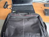 a laptop and a laptop bag sitting on a desk