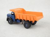 an orange and blue toy dump truck on a white surface