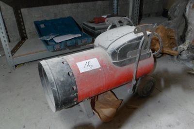 a red and white blow dryer sitting in a garage
