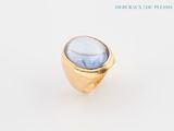 an image of a gold ring with a blue stone in it