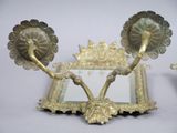 a mirror with a pair of candles on it and a mirror with two candles on it