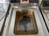 a fryer that has a fork sticking out of it