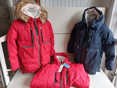 three jackets on a white chair in a room