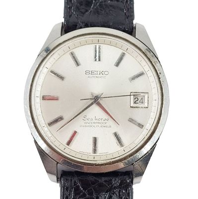 a close up of a watch on a white background