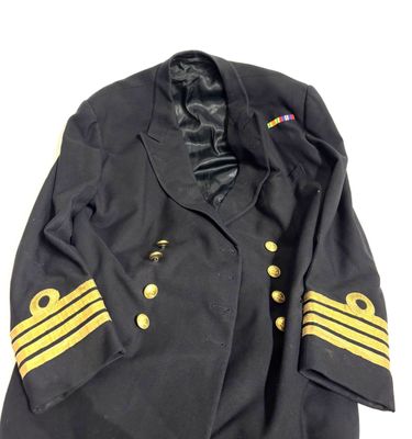 an old black military jacket with gold stripes and buttons