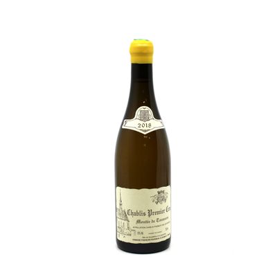 the bottle of wine is sitting on a white surface