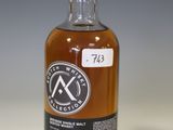 an empty bottle of whisky sitting on a table