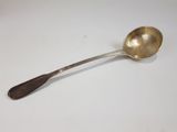 a silver spoon with a wooden handle on a white surface