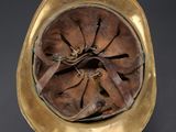 an old brass helmet with a hole in the middle of it